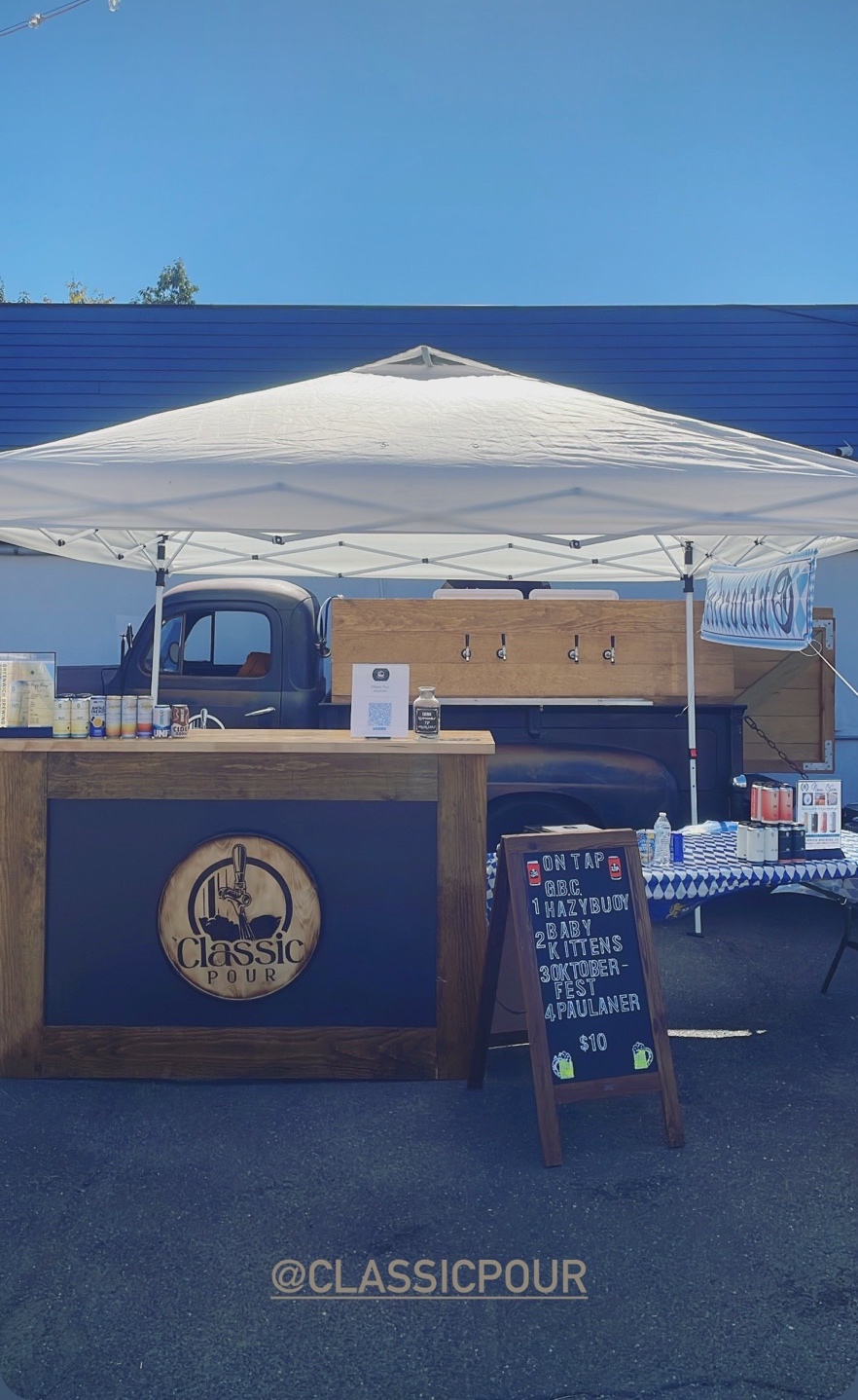 Classic Pour mobile bar setup under a white tent